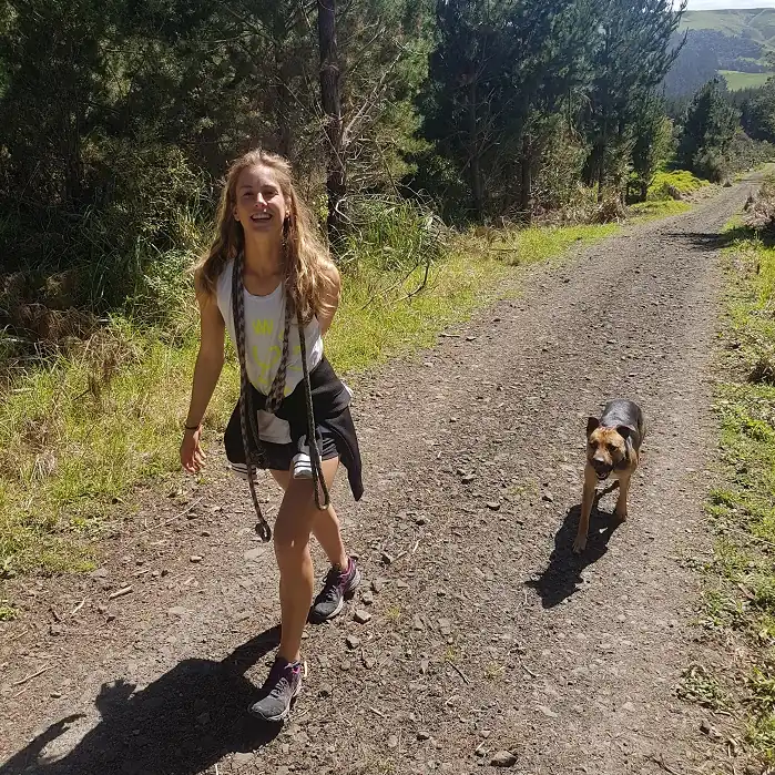 The manager of Good Dog Training Amber walking alongside a Dog practicing its off leash skills.